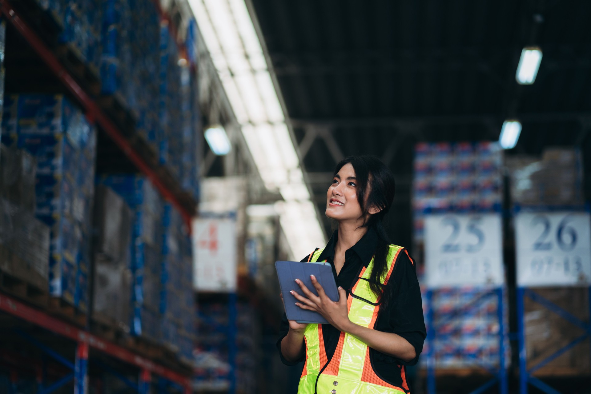 Warehouse worker working and checking the stock in the warehouse. .Factory manager using digital tablet check barcode in industry factory logistic.